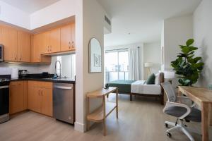 a kitchen and a living room with a table at Central Penthouse Studio with Free Parking in Los Angeles