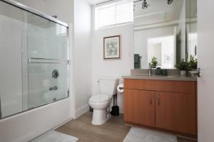 a bathroom with a toilet and a shower and a sink at Central Penthouse Studio with Free Parking in Los Angeles