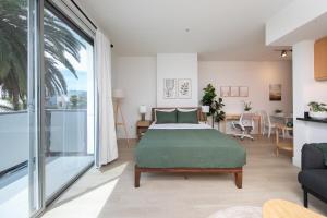 a bedroom with a bed and a living room at Central Penthouse Studio with Free Parking in Los Angeles