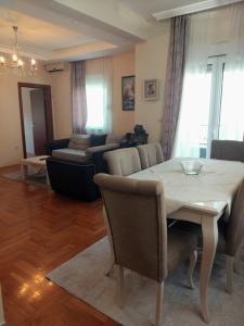 a living room with a table and a couch at Apartman Budva in Budva