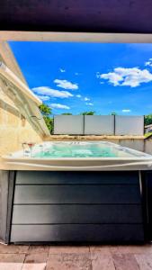 a jacuzzi tub on top of a building at Loft Deliciae in Remoulins