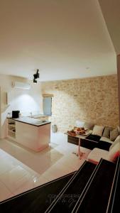 a kitchen and a living room with a couch at Loft Deliciae in Remoulins +62 photos