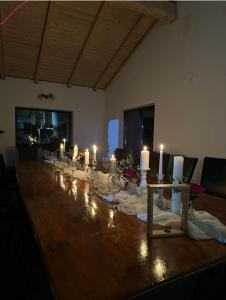 a long table with candles on top of it at CozyCloud in Poiana Mărului +6 photos