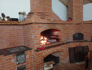 a brick oven with a fire in it at CozyCloud in Poiana Mărului
