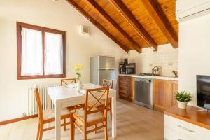 a kitchen with a table and chairs in a room at TRAIN HOUSE in Treviso