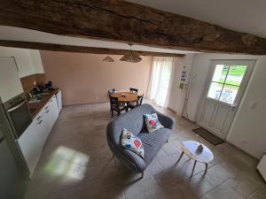 a living room with a couch and a table at Au pré de Mimi in Lalande-en-Son