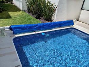 a swimming pool with a blue inflatable at Comfortable, equipped house for long stays in Juriquilla