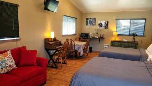 a room with a bed and a couch and a desk at Dodge Peak Lodge in Bonners Ferry