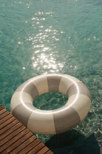 a white inflatable raft in a pool of water at Tenute Allegretti Casa in Montalbano