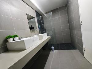 a bathroom with two sinks and a mirror at DH Villa in Batu Caves +11 photos