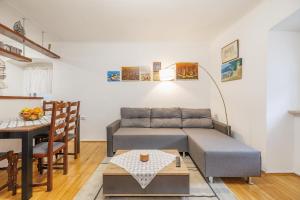 a living room with a couch and a table at Castua Residence in Kastav