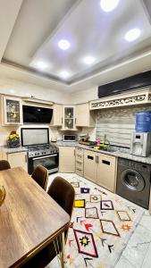 a large kitchen with a table and a dining room at مدينة الشرق الزرقاء in Az Zarqa