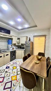 a kitchen with a wooden table and chairs at مدينة الشرق الزرقاء in Az Zarqa +32 photos