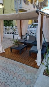 a wooden deck with a umbrella and chairs and tables at Cordi Casa Vacanze in Giulianova