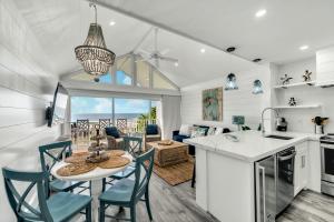 a kitchen and living room with a table and chairs at Coconuts Beachfront #112 in Holmes Beach