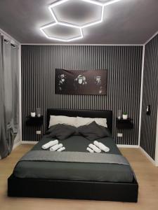 a bedroom with a large bed with black stripes at la mengola holiday and relax in Trivio +50 photos
