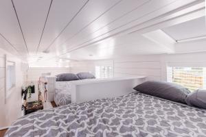 two beds in a bedroom with white walls at Zion Family Adventure Hub Hiking MTB in Apple Valley