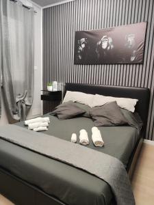 a bedroom with a bed with slippers on it at la mengola holiday and relax in Trivio