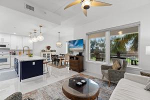 a kitchen and living room with a couch and a table at Fishermans Landing on The Bay- Las Marinas in South Padre Island
