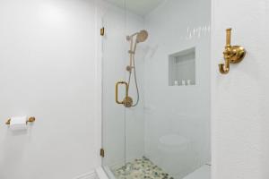 a shower with a glass door in a bathroom at Fishermans Landing on The Bay- Las Marinas in South Padre Island