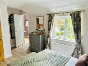 a bedroom with a bed and a window at Brackengarth House in Purdysburn