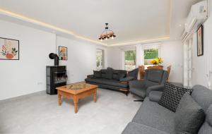 a living room with two couches and a table at Villa Kısmet in Fethiye