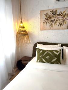 a bedroom with a white bed and a pendant light at Casa Natali 1 in Fuengirola