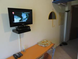a television on a wall in a room at Gli Oleandri in Capoliveri