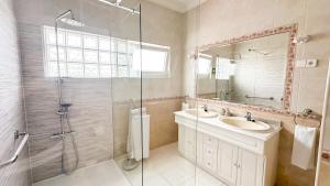 a bathroom with a shower and a sink and a mirror at Pátio Privado com Churrasqueira by Férias em Figueira in Figueira da Foz +46 photos