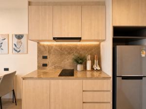 a kitchen with a counter and a refrigerator at Cozy 1 BR Bangtao Beach in Laguna Phuket +5 photos