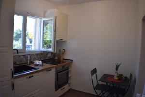 a kitchen with a sink and a table with chairs at Kasamare- Monopoli in Monopoli