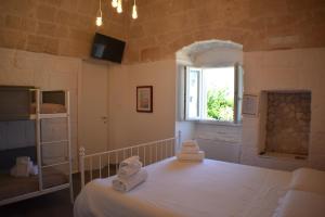 a bedroom with a bed with two towels on it at Kasamare- Monopoli in Monopoli