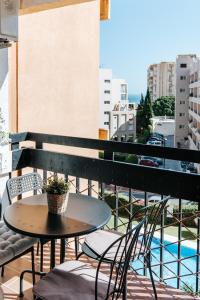 a table on a balcony with a view of a city at Home Corinto Beach terraza y piscina - Benalmadena Malaga in Benalmádena