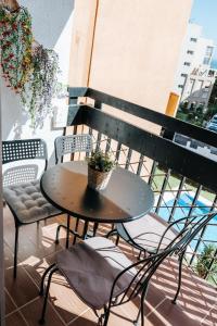 a small table and chairs on a balcony at Home Corinto Beach terraza y piscina - Benalmadena Malaga in Benalmádena