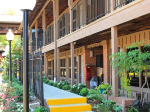 a building with yellow steps in front of a building at Charles Wesley Motor Lodge Downtown Broken Bow- Hochatown in Broken Bow
