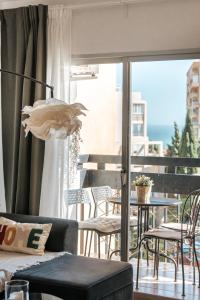 a living room with a patio with a table and chairs at Home Corinto Beach terraza y piscina - Benalmadena Malaga in Benalmádena
