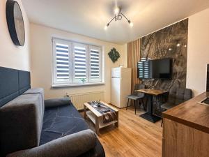 a living room with a couch and a table at IN Apartments in Prešov