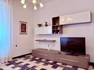 a living room with a flat screen tv at Sea View Apartment - Private Parking AC in Savona