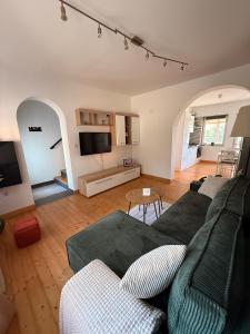 a living room with a couch and a tv at Kuća za odmor Gaia in Vukovar