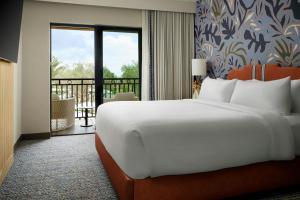 a bedroom with a large bed and a balcony at Hotel Solea, Autograph Collection in Carlsbad +53 photos