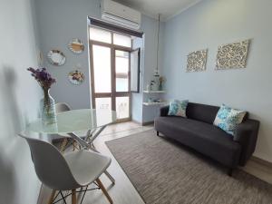 a living room with a glass table and a couch at V4 in Horta