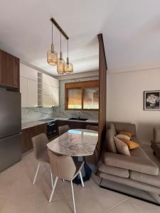 a kitchen and living room with a table and a couch at ORDAMS Villa in Himare