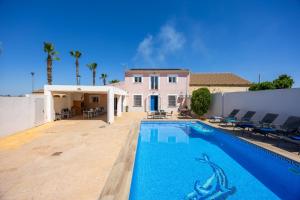 a swimming pool in front of a house at Blue Haven by Fidalsa in Catral
