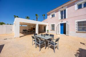 a patio with a table and chairs in front of a house at Blue Haven by Fidalsa in Catral