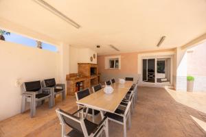 a dining room with a table and chairs at Blue Haven by Fidalsa in Catral