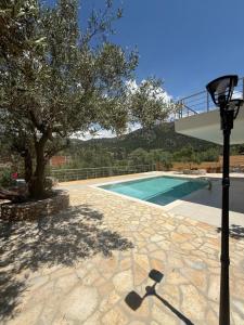 a light pole next to a swimming pool at ORDAMS Villa in Himare