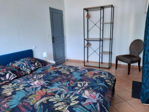 a bedroom with a bed and a chair and a ladder at Le Petit Moulin de Verberie in Verberie