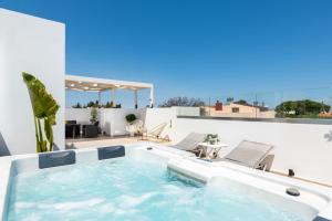 a hot tub on the roof of a house at Sunny Palm Villa in Ialysos