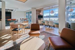 a living room with a table and chairs and a dining room at SpringHill Suites by Marriott Phoenix Gilbert in Gilbert