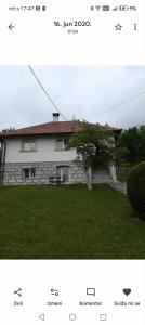 a picture of a house with a tree in the yard at Studio u selu Mačkat in Mačkat +4 photos